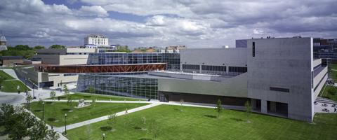 Exterior of the Recreation and Physical Activity Center with its curved glass facade.